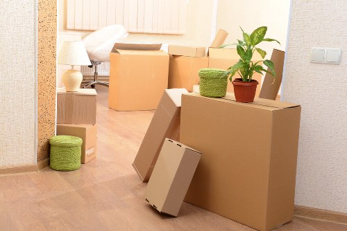 Careful wrapping of fragile household items during packing services in Erith